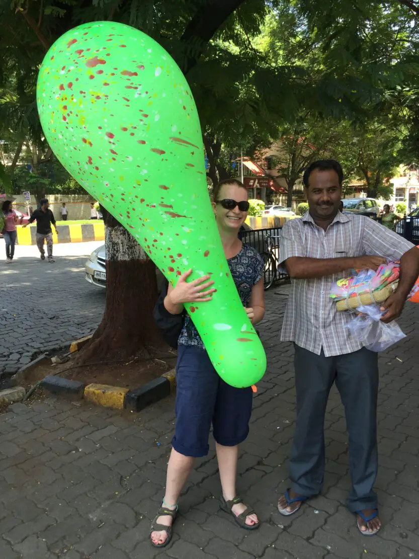 Tanya holding giant green balloon next to giant balloon Seller in Mumbai