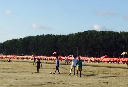 Red parasols and sunloungers Cox's Bazar Beach Bangladesh