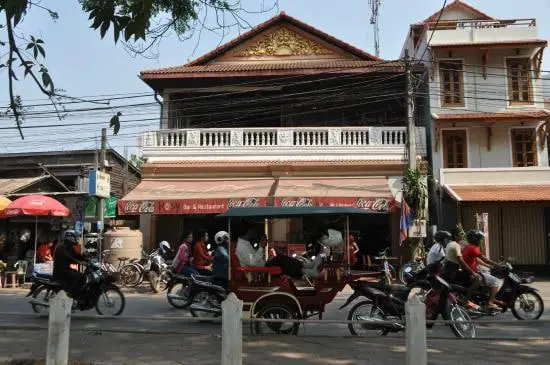 Rosy Guest House with tuk tuks and motos outside in Siem Reap, Cambodia