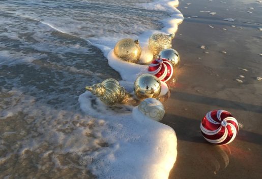 Favourite Christmas Travel Experience, Baubles in the sea on the beach.