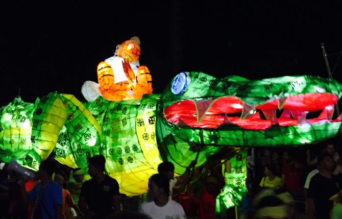 giant puppet parade Siem Reap Cambodia Crocodile puppet lit up at night