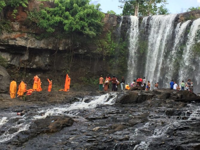 Monks bathing at Bou Sra Waterfall in Mondulkiri, Cambodia