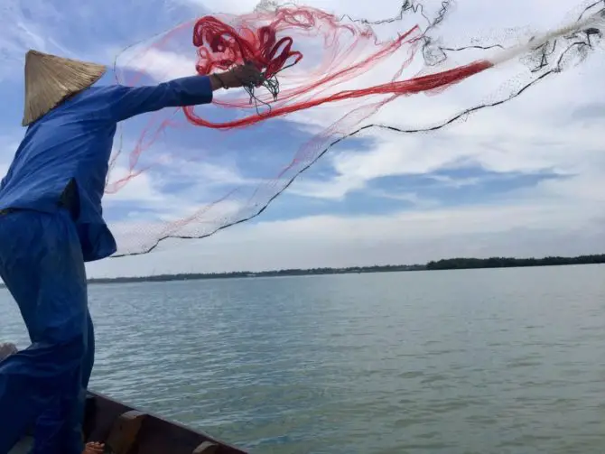 Vietnamese Fisherman Cast Net Fishing in Hoi An, Vietnam