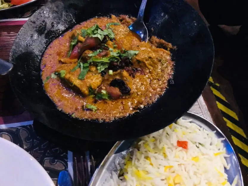 Tomato based curry in black iron dish at Tayyabs