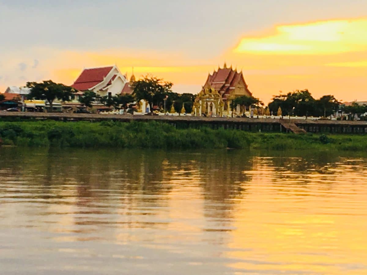 Sunset over the river in Nakhon Phanom on our 3-day itinerary.