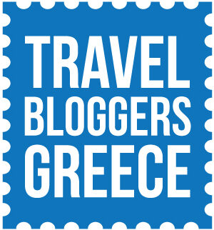 Travel Bloggers Greece logo. Blue Stamp with white writing in capitals saying 'TRAVEL BLOGGERS GREECE'