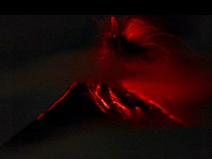 Volcano Fuego erupting red molten lava on the Acatenango Volcano trek