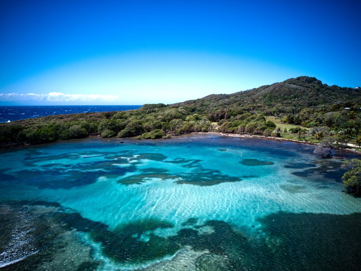 Best Things to Do on Roatan in Honduras. Aerial view of deserted beach in Honduras