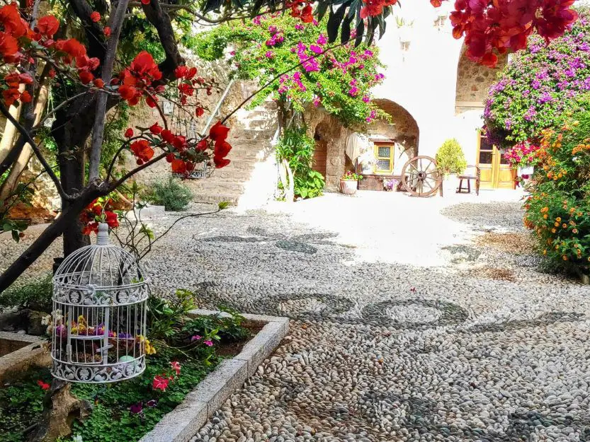Beautiful, flower-filled courtyard at Archontiko Hatzipanayioti Hotel in Leonidio, Peloponnese