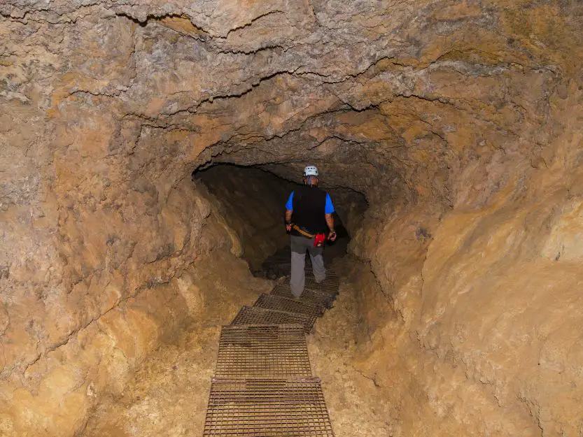 Cueva del Viento, The Wind Cave. Image of man walking down cave tunnel.