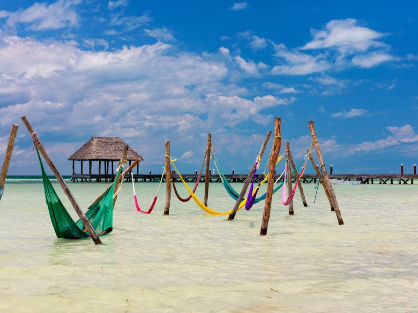 Ferry to Isla Holbox - image of colourful hammocks in the sea