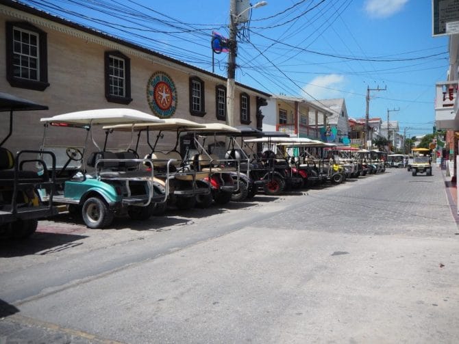 Golf carts lined up in the street in San Pedro, Belize