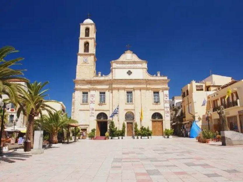 Greek Orthodox Church in Chania, Crete. Palm trees in front left foreground.