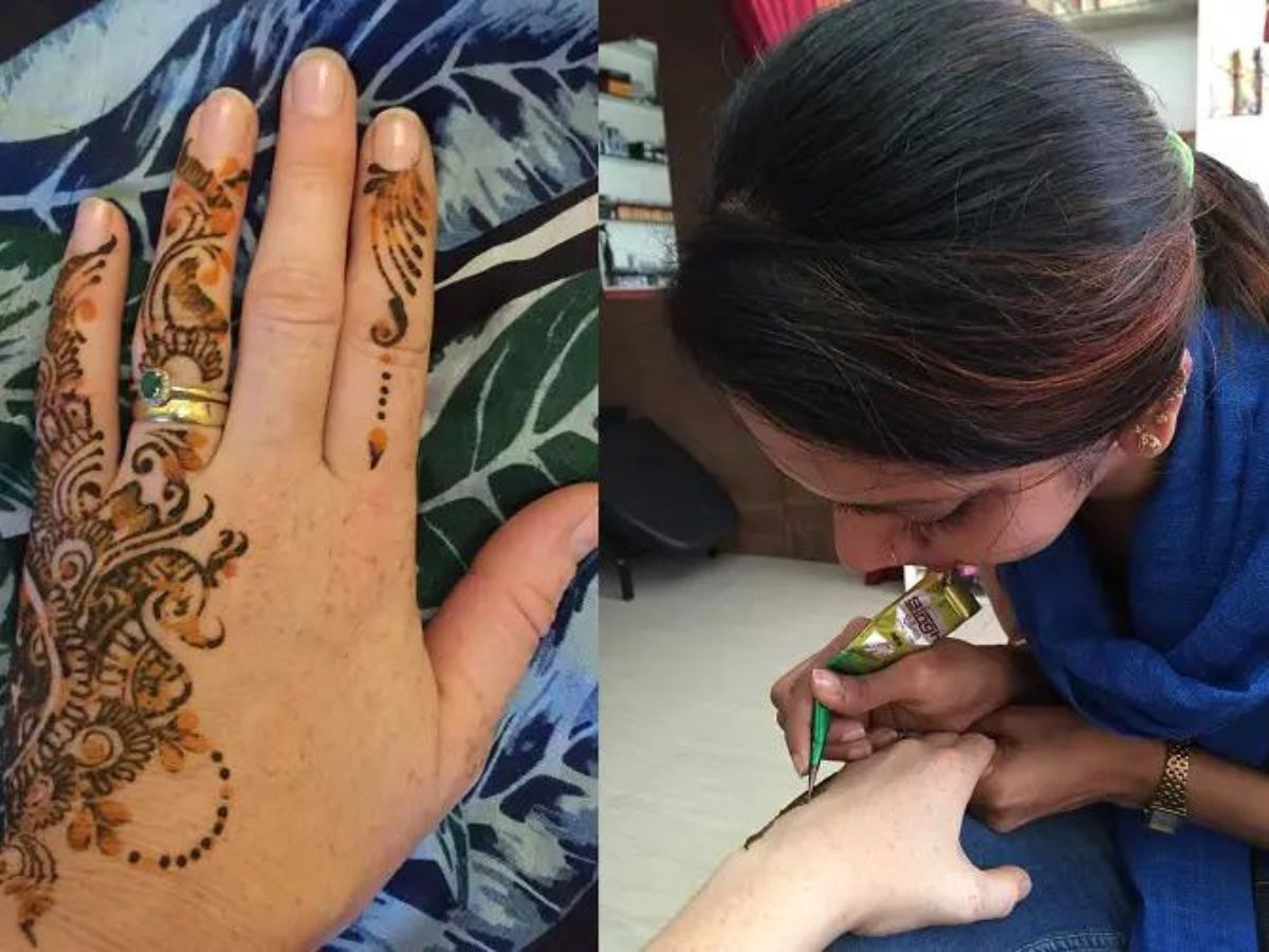 Tanya's hennaed hand on the left side of the image and the lady tattoist with black haird and blue shirt on the right.