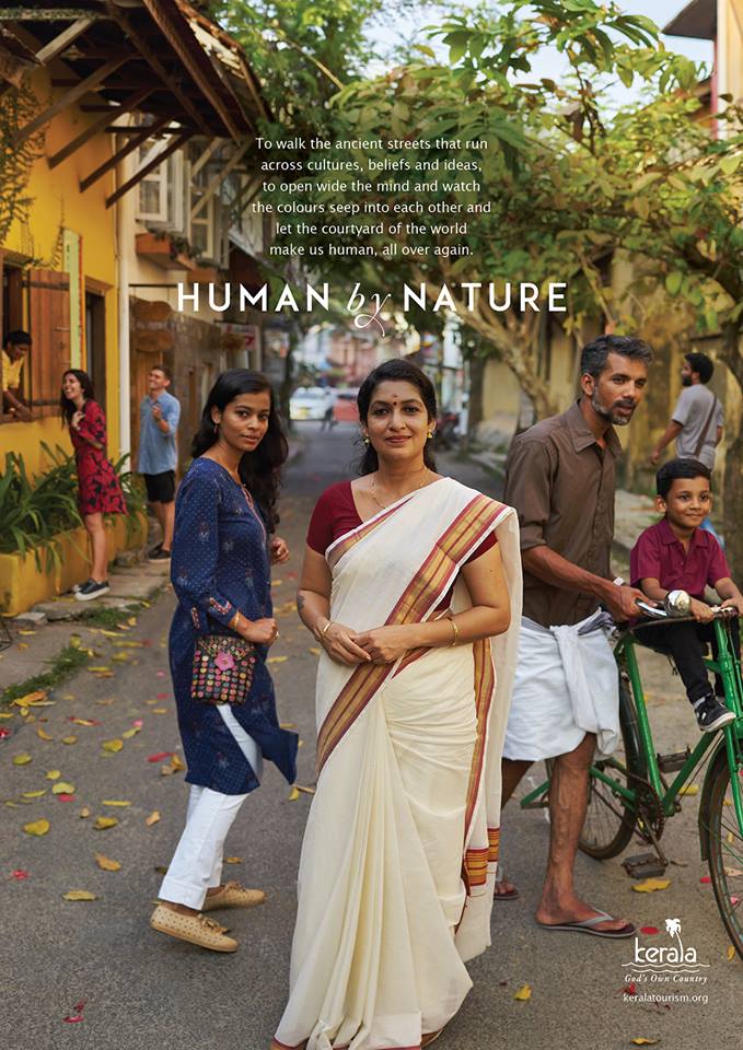 An Indian family dressed in nice smart clothes in the street in Kochi, Kerala.