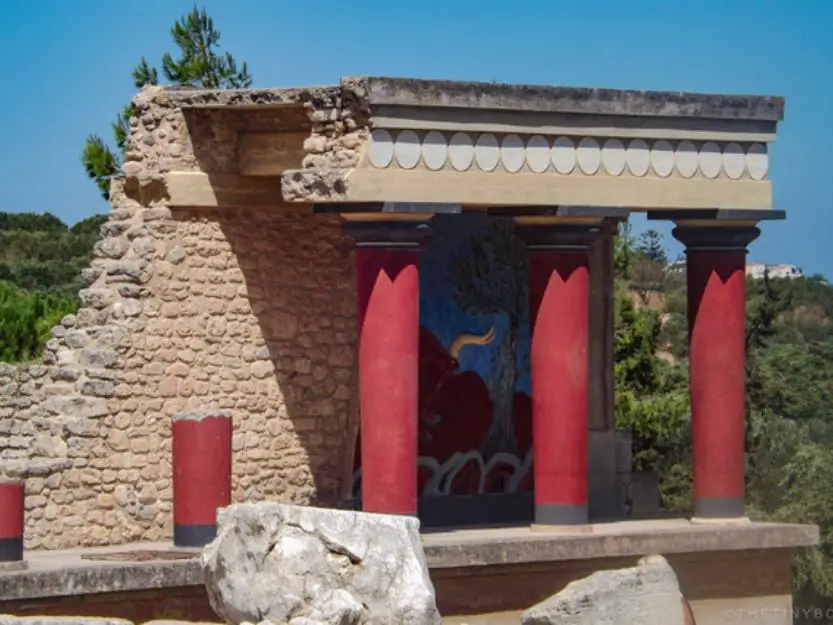 Knossos in Heraklion on Crete Island - beige stone temple with red columns