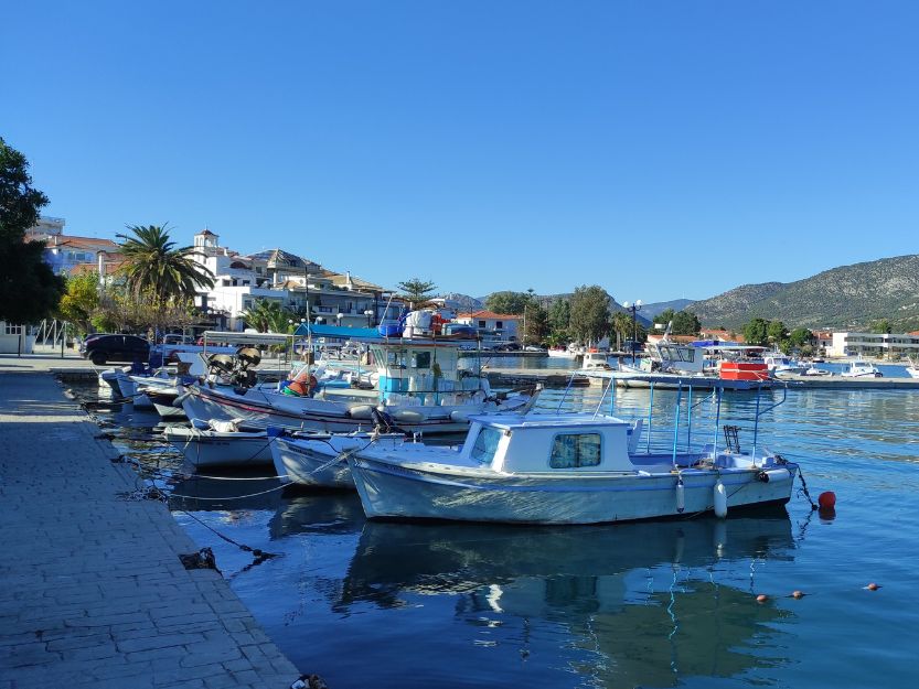 Colourful boats moored lined up on Limani side of Ermioni Greece