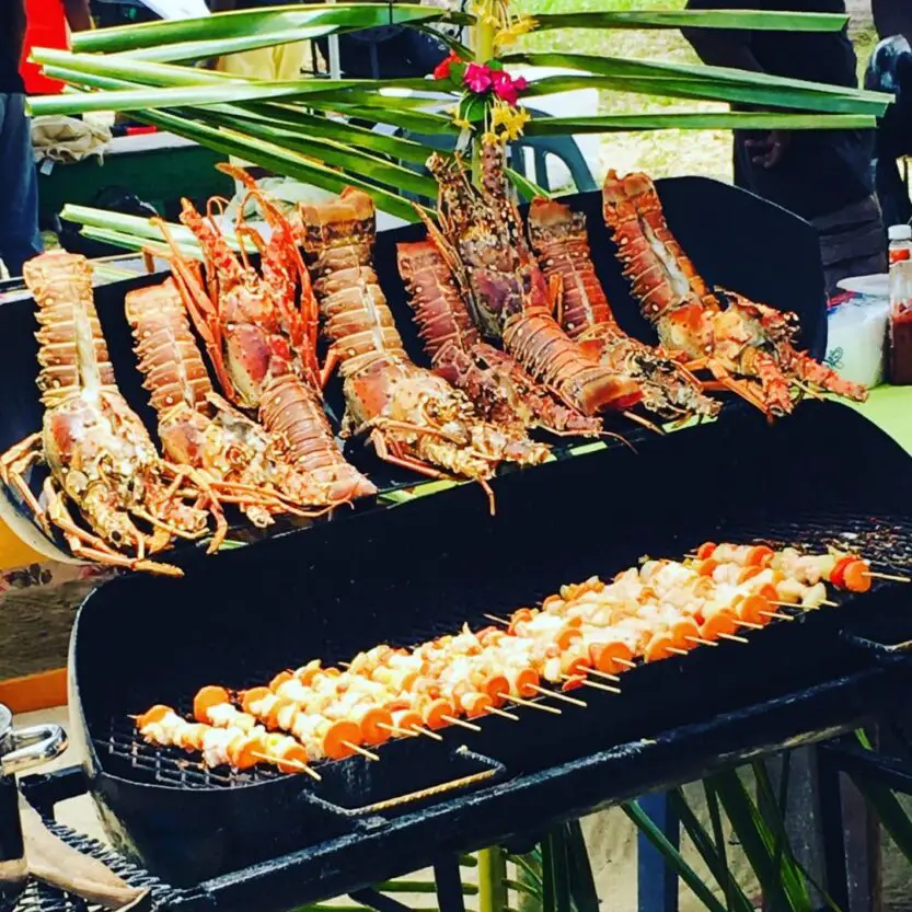 Lobsters on the grill at Placencia Lobster Festival in Belize.