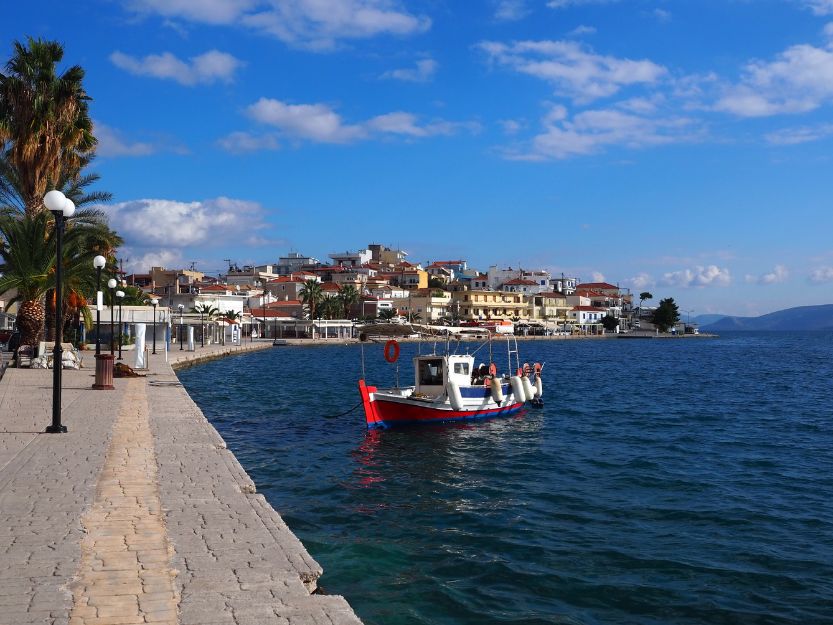 Mandrakia side of Ermioni with a blue and red boat in the foreground.