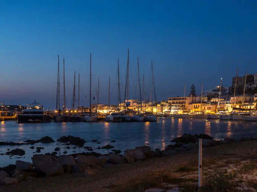 A bay full of yachts on Naxos Island in Greece at night.