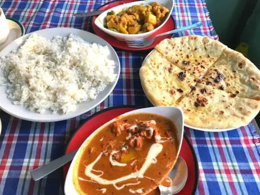 Nepali Cuisine in Pokhara on a blue and red checked table cloth.