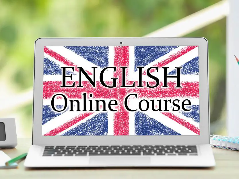 Online English Teaching, Image of a silver laptop screen with the red, white and blue Union Jack Flag with a blurred green background.