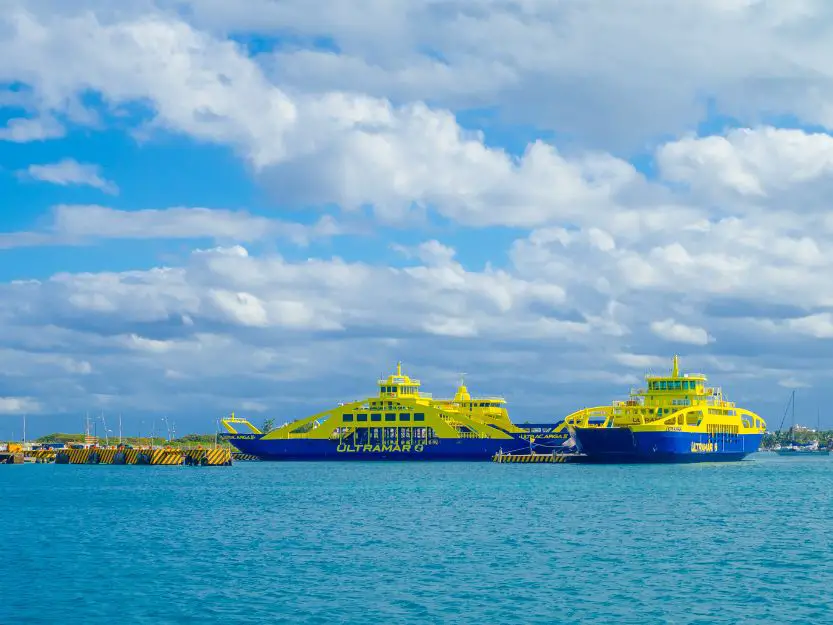 Places you can reach by ferry in Mexico - image of two blue and yellow ferries in a port