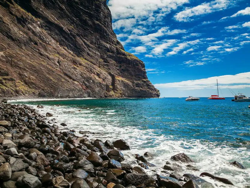 Playa de Masca, Tenerife. Image of rocky beach and cliffs to left and blue sea and sky to the right