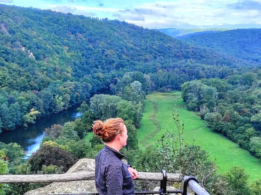Tanya looking out over green hills and trees in Podiyji National Park and Dyje River