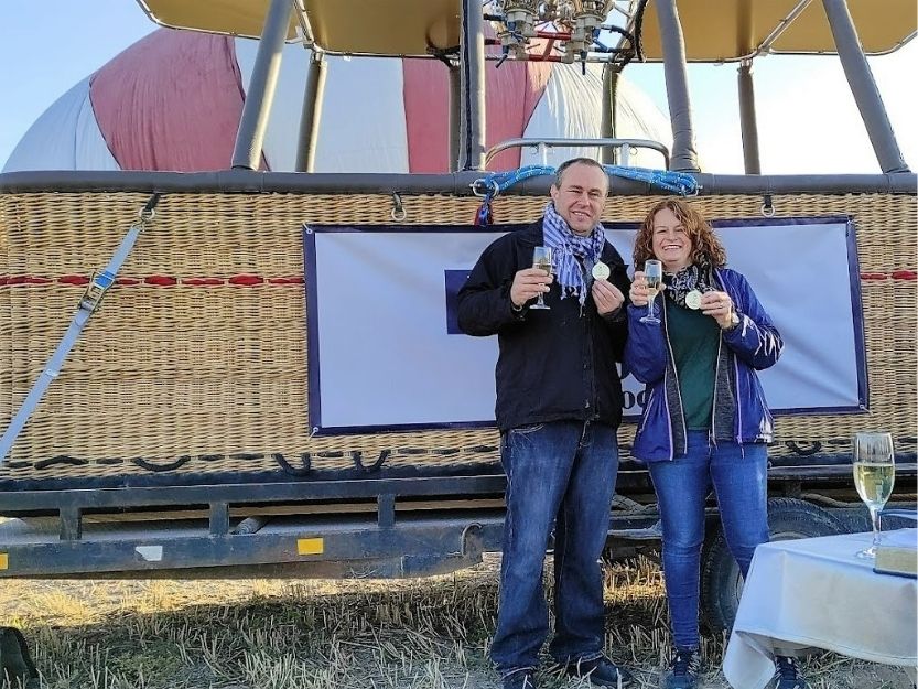 Tanya and Andy standing in front of a Royal Balloon hot air balloon basket