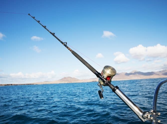 Sea Fishing near Placencia Belize. Fishing rod on a boat.