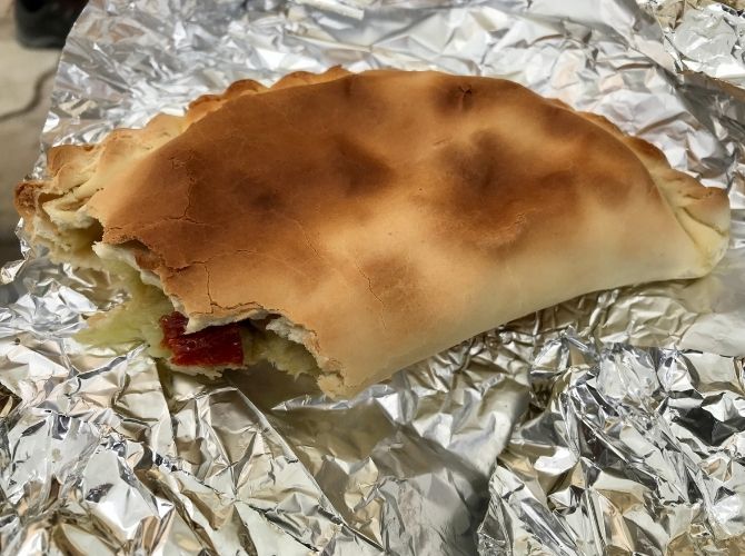 Sicilian scaccia. A folded flatbread stuffed with various fillings. Looks like a cornish pasty.