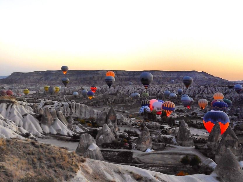 View of hot air balloons at sunrise from Sunrise point/ Lovers Hill in Goreme Cappadocia