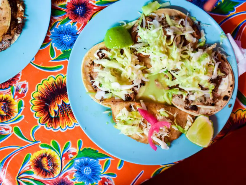 Tacos Al Pastor in Tulum in Mexico, served on a colourful table cloth.