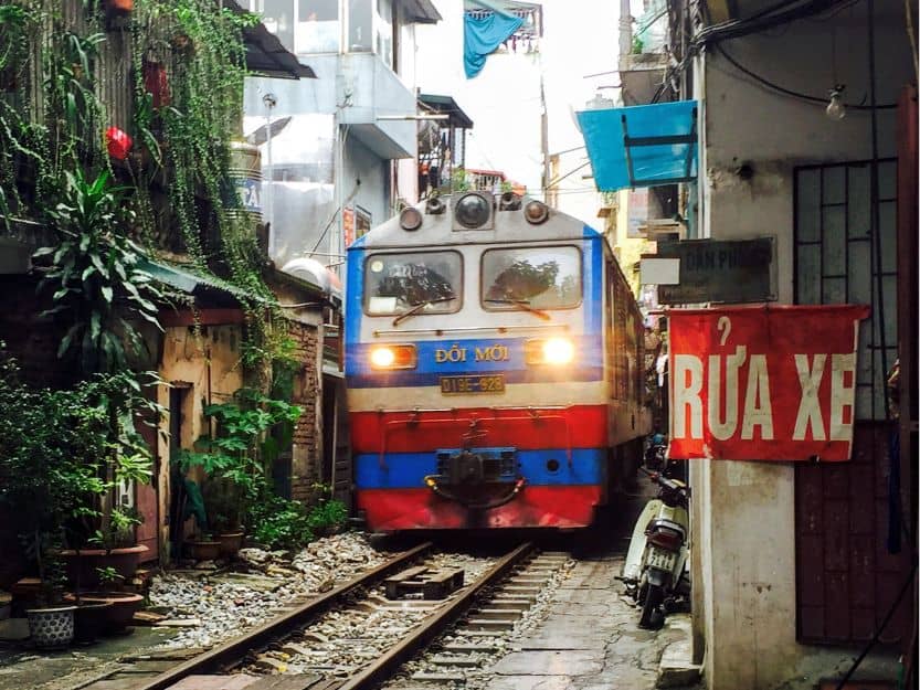 Train on Train Street in Hanoi Blue, red, and white train on Train Street in Hanoi
