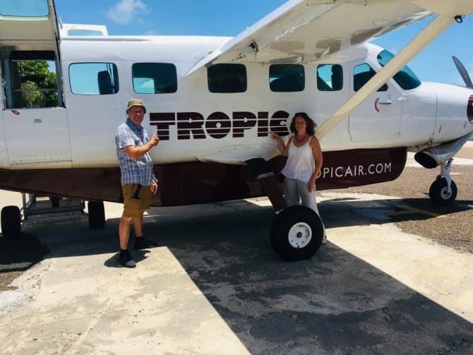 Tropic Air Belize Plane with Tanya and Andy standing in front of it.