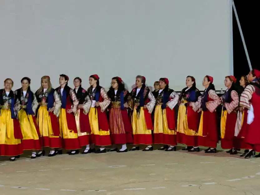 Tsakonian cultural show, women dancers dressed in red and yellow costumes.