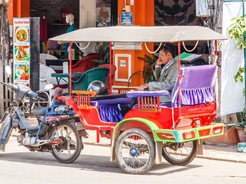 Colourful tuk-tuk and driver in Siem Reap, Cambodia
