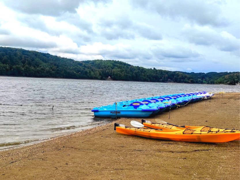 Blue pedalos and orange kayaks at Vranovska Platz Holiday Park in Czech Republic